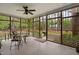 Screened-in back porch with ceiling fan and a view of the backyard and woods at 108 Cedarwood Dr, Louisburg, NC 27549