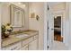 Charming powder room with granite countertop, decorative mirror, and neutral wall color at 108 Cedarwood Dr, Louisburg, NC 27549