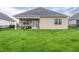 Large backyard with green lawn, black fence, covered patio, and outdoor seating at 1096 Aberlour Ln, Burlington, NC 27215