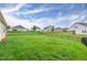 The expansive backyard, enclosed by a black metal fence, offers ample space for outdoor activities at 1096 Aberlour Ln, Burlington, NC 27215