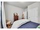 Bright bedroom with a neutral color palette, a wood dresser, and a chair with patterned pillows at 1096 Aberlour Ln, Burlington, NC 27215