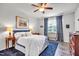 Cozy bedroom with a ceiling fan, blue rug, and natural light from the window at 1096 Aberlour Ln, Burlington, NC 27215