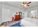 Comfortable bedroom featuring hardwood floors, a ceiling fan, and a wooden dresser at 1096 Aberlour Ln, Burlington, NC 27215