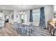 Bright dining room with a white table, chairs, and large windows with patterned curtains at 1096 Aberlour Ln, Burlington, NC 27215