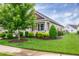 Charming home featuring a tan exterior, manicured lawn, and a welcoming front porch at 1096 Aberlour Ln, Burlington, NC 27215