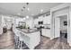 Modern kitchen with stainless steel appliances, a large island with seating, and white cabinets at 1096 Aberlour Ln, Burlington, NC 27215