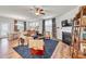 Inviting living room with fireplace, dining area, blue rug, and comfortable seating at 1096 Aberlour Ln, Burlington, NC 27215