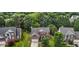 Aerial view of a beautiful brick home with a well-manicured lawn and surrounded by lush trees at 110 Fairchild Downs Pl, Cary, NC 27518