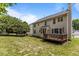 Spacious backyard featuring a well-maintained lawn, mature trees, and a deck for outdoor entertaining at 110 Fairchild Downs Pl, Cary, NC 27518