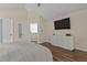 Bedroom featuring a bed, a mounted television, a dresser, and wood flooring at 110 Fairchild Downs Pl, Cary, NC 27518