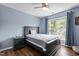 Comfortable bedroom featuring a black bed frame, a nightstand, and a window overlooking the greenery at 110 Fairchild Downs Pl, Cary, NC 27518