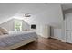 Attic bedroom featuring sloped ceilings, wood floors, a bed, a dresser, and a ceiling fan at 110 Fairchild Downs Pl, Cary, NC 27518