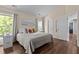 Bedroom featuring hardwood floors, natural lighting, cream colored walls and ceiling, and neutral colored bedding at 110 Fairchild Downs Pl, Cary, NC 27518
