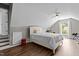 Attic bedroom featuring sloped ceilings, wood floors, a bed, a window, and a ceiling fan at 110 Fairchild Downs Pl, Cary, NC 27518