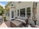 Comfortable outdoor seating area with neutral-colored sofa on a wood deck, perfect for relaxing at 110 Fairchild Downs Pl, Cary, NC 27518