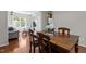 Bright dining area featuring hardwood floors and views into the living room at 110 Fairchild Downs Pl, Cary, NC 27518