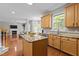 Bright kitchen with granite countertops, a central island, and hardwood floors at 110 Fairchild Downs Pl, Cary, NC 27518
