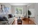 Cozy living room with hardwood floors, large window, and neutral decor at 110 Fairchild Downs Pl, Cary, NC 27518
