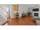 Open-concept living room features hardwood floors, a fireplace, and a cozy sitting area at 110 Fairchild Downs Pl, Cary, NC 27518