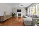 Open living room with a fireplace, hardwood floors, and lots of natural light at 110 Fairchild Downs Pl, Cary, NC 27518