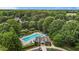 Community pool featuring ample seating, manicured landscaping, and a clubhouse at 110 Fairchild Downs Pl, Cary, NC 27518