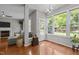 Bright sunroom features hardwood floors, a modern chandelier, and large windows overlooking the backyard at 110 Fairchild Downs Pl, Cary, NC 27518