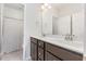 Bright bathroom featuring a double sink vanity, decorative mirrors, and ample storage space at 1101 Hazelmist Dr, Youngsville, NC 27596