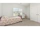 Cozy bedroom featuring a colorful floral bedspread, ample natural light, and closet at 1101 Hazelmist Dr, Youngsville, NC 27596