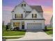 Inviting two-story home features sunset view, manicured lawn, and attached garage with driveway at 1101 Hazelmist Dr, Youngsville, NC 27596