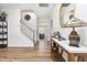 Inviting hallway features gleaming wood floors, staircase, decorative accents, and stylish table at 1101 Hazelmist Dr, Youngsville, NC 27596