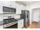 Well-equipped kitchen with stainless steel appliances, white cabinets, and subway tile backsplash at 1101 Hazelmist Dr, Youngsville, NC 27596