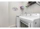 Bright laundry room with new LG washer and dryer, storage shelf and fun decor sign at 1101 Hazelmist Dr, Youngsville, NC 27596