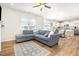 Cozy living room with plush sofa, wood floors, and open floor plan at 1101 Hazelmist Dr, Youngsville, NC 27596