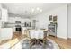 Open living and dining area with stainless appliances, modern lighting, and backyard views at 1101 Hazelmist Dr, Youngsville, NC 27596