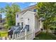 Angled view of the home's backyard with a white picket fence, patio, and lush greenery at 111 Chancellors Ridge Dr, Durham, NC 27713