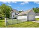 Backyard featuring the house with deck and detached garage beyond the white picket fence at 111 Chancellors Ridge Dr, Durham, NC 27713