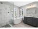 Elegant bathroom featuring soaking tub, glass shower, and custom vanity at 111 Chancellors Ridge Dr, Durham, NC 27713