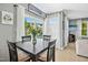 Bright dining area with natural light, a dark wood table set, and sliding door access to the outdoor living space at 111 Chancellors Ridge Dr, Durham, NC 27713
