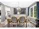 Elegant dining room with modern light fixture and view to the kitchen area at 111 Chancellors Ridge Dr, Durham, NC 27713