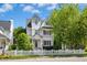 Charming two-story home featuring a beautiful white picket fence and well-manicured landscaping at 111 Chancellors Ridge Dr, Durham, NC 27713
