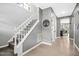 Light-filled hallway with staircase, leading to open-concept living and kitchen areas at 111 Chancellors Ridge Dr, Durham, NC 27713