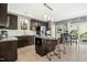 The kitchen boasts an island with seating and updated appliances, connecting seamlessly to the dining and outdoor areas at 111 Chancellors Ridge Dr, Durham, NC 27713