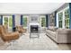 Inviting living room featuring a fireplace, hardwood floors, and large windows for natural light at 111 Chancellors Ridge Dr, Durham, NC 27713