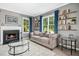 Inviting living room featuring a fireplace, hardwood floors, and built-in shelving at 111 Chancellors Ridge Dr, Durham, NC 27713