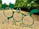 A fun dog park with play structures on a wood mulch surface surrounded by green trees at 114 Constitution Dr, Durham, NC 27705