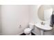This powder room features pedestal sink, oval mirror, and neutral color palette at 114 Constitution Dr, Durham, NC 27705