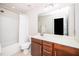 Clean bathroom features a shower/tub combo, dark wood cabinets, and a large framed mirror at 114 Constitution Dr, Durham, NC 27705