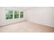 A sunlit bedroom with neutral walls and carpet offers a serene and inviting space at 114 Constitution Dr, Durham, NC 27705