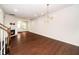 Spacious area with hardwood floors leading to a living area with a fireplace at 114 Constitution Dr, Durham, NC 27705