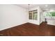 Empty dining room with hardwood floors, modern light fixture, and a view into the kitchen at 114 Constitution Dr, Durham, NC 27705